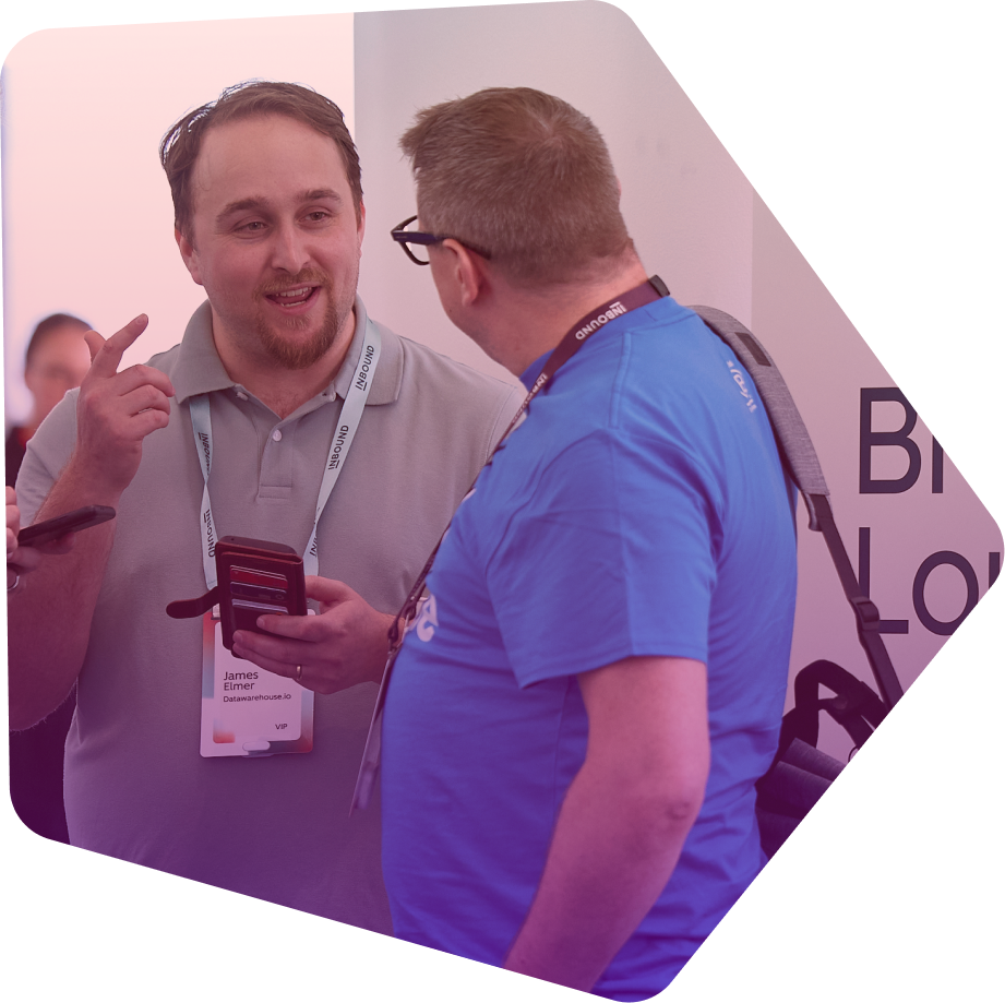 Two men in business attire having a conversation at a conference