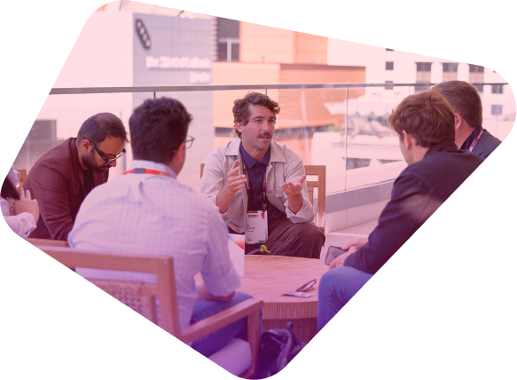 Business professionals having a discussion around a table in a modern office setting