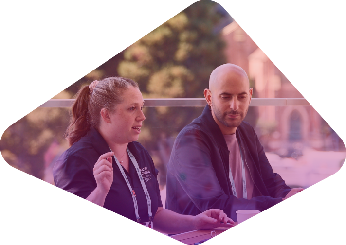 Two professionals having a conversation at an outdoor conference
