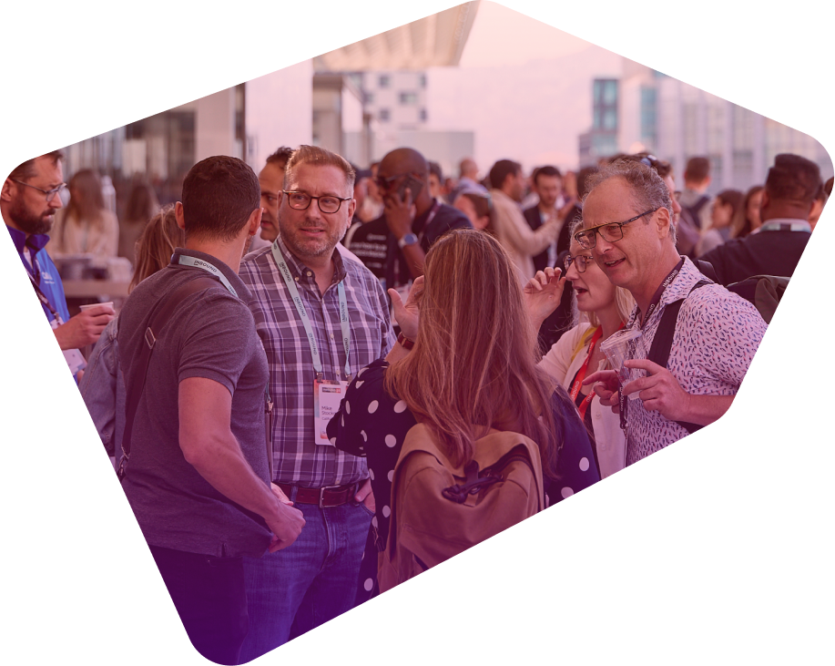 Group of professionals networking and conversing at an outdoor conference event